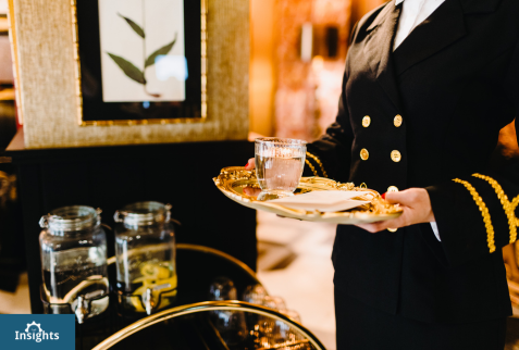 Hotel Clerk Prepares to Serve a Guest